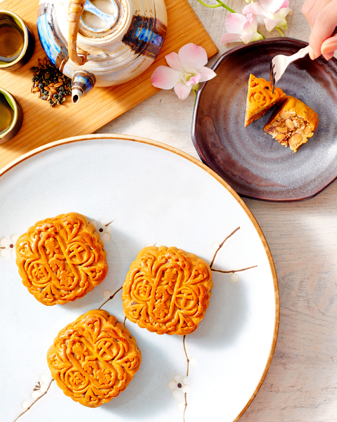 A family enjoying mooncakes under the full moon during Mid-Autumn Festival.
