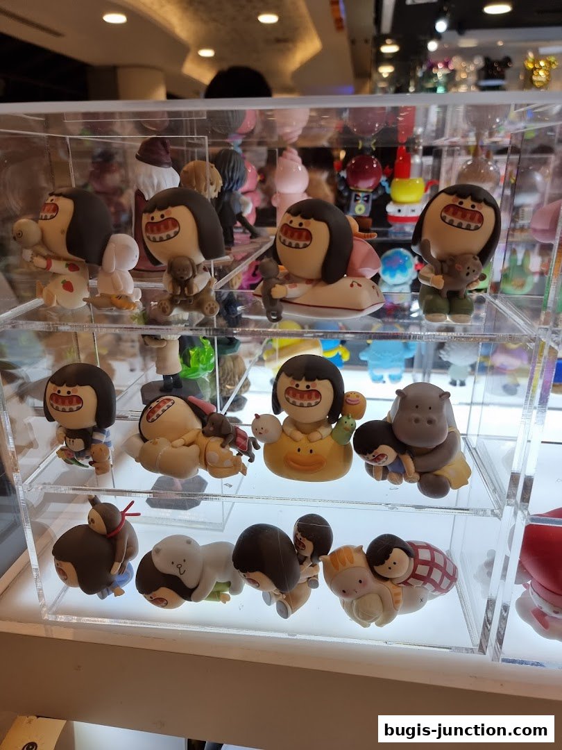 A display case filled with various collectible designer toys and figurines.