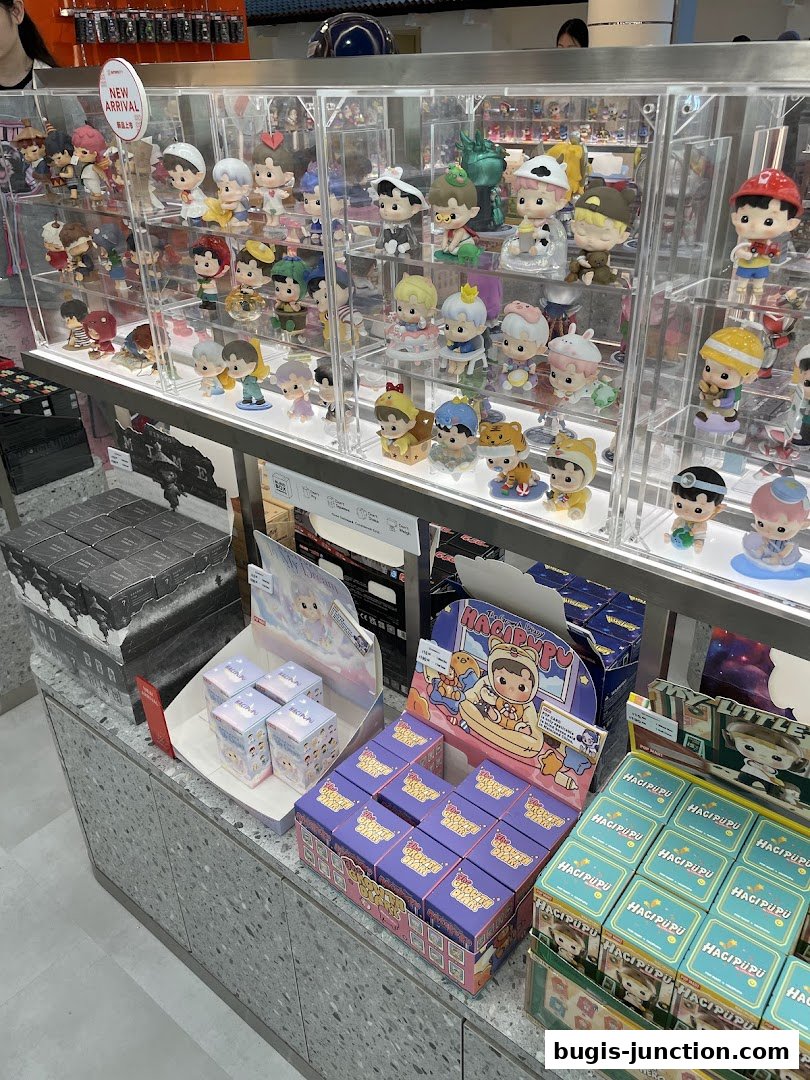 A display case filled with collectible figurines and boxes of blind box toys.