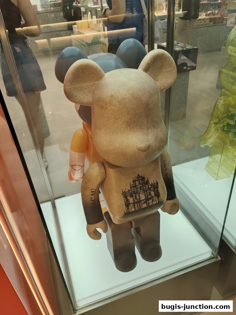 A display window showcases collectible designer toys with a Macau theme.