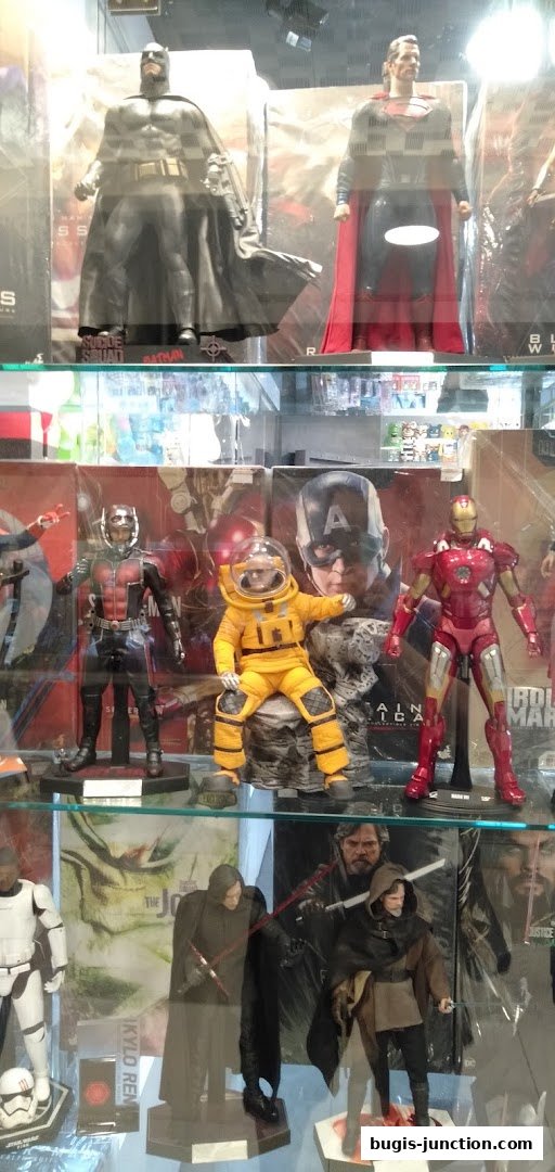 Display case filled with collectible action figures of popular superheroes and movie characters.
