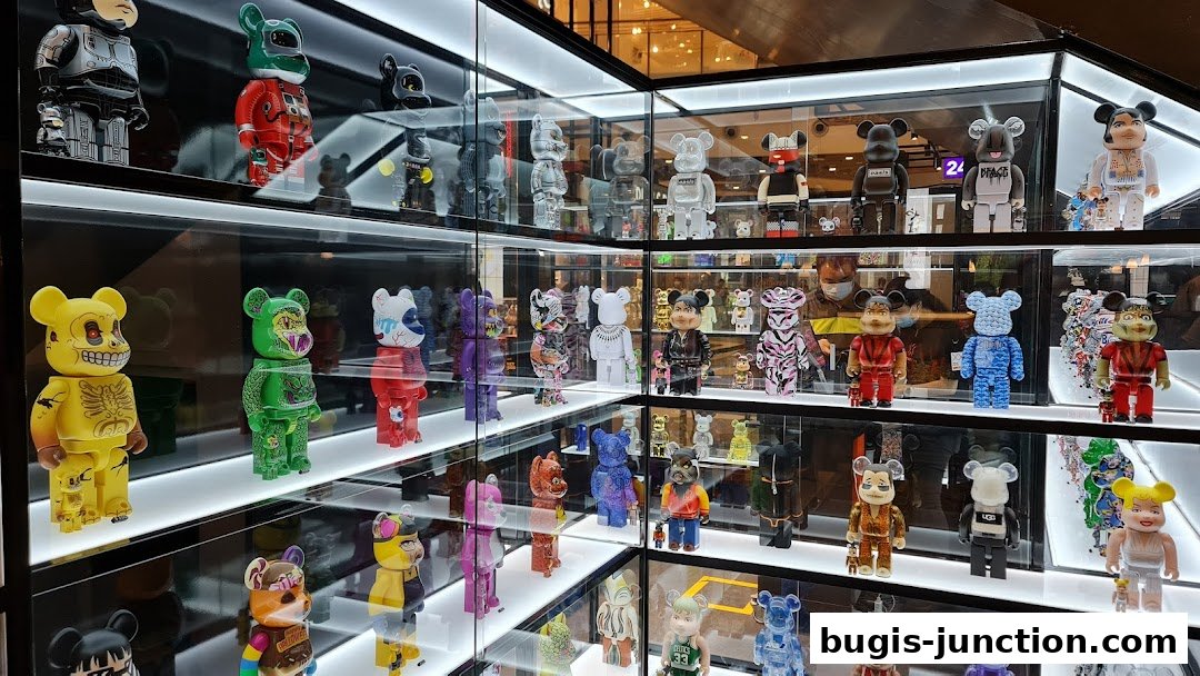 A display of various collectible designer toys in a brightly lit retail store.