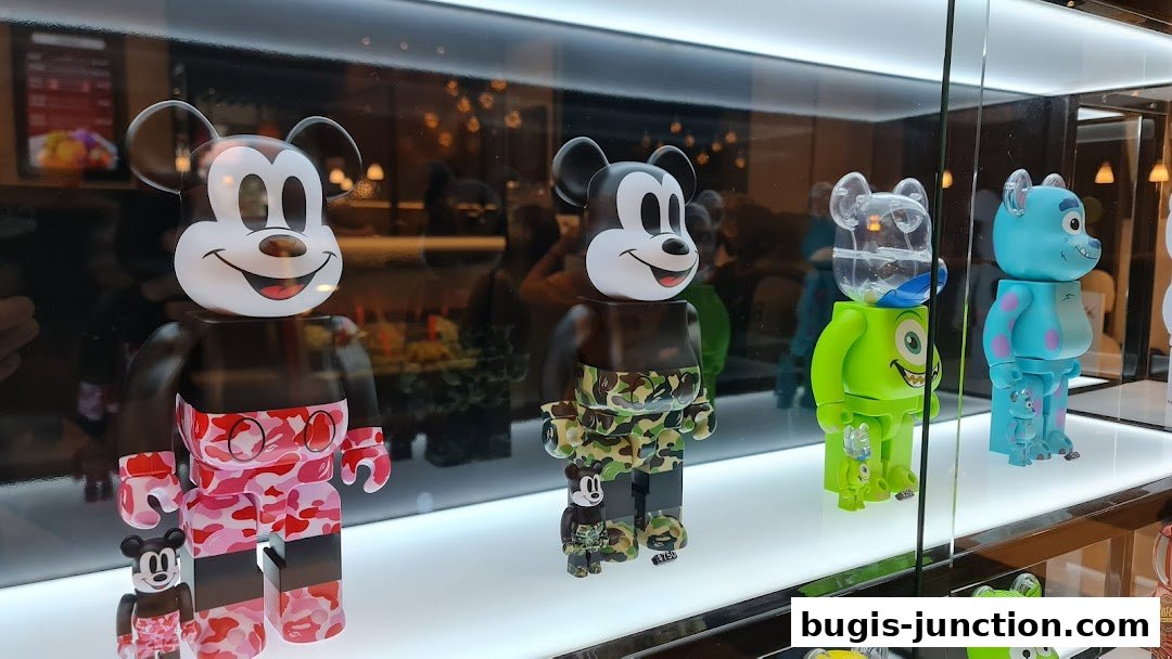 Display of collectible designer toys featuring Mickey Mouse and Monsters Inc. characters.