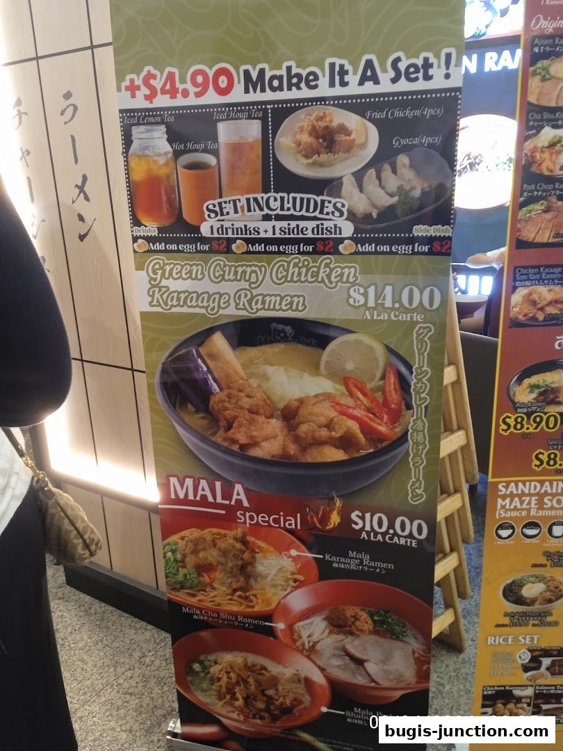 A promotional banner for Ajisen Ramen featuring a Green Curry Chicken Karaage Ramen set and Mala specials.