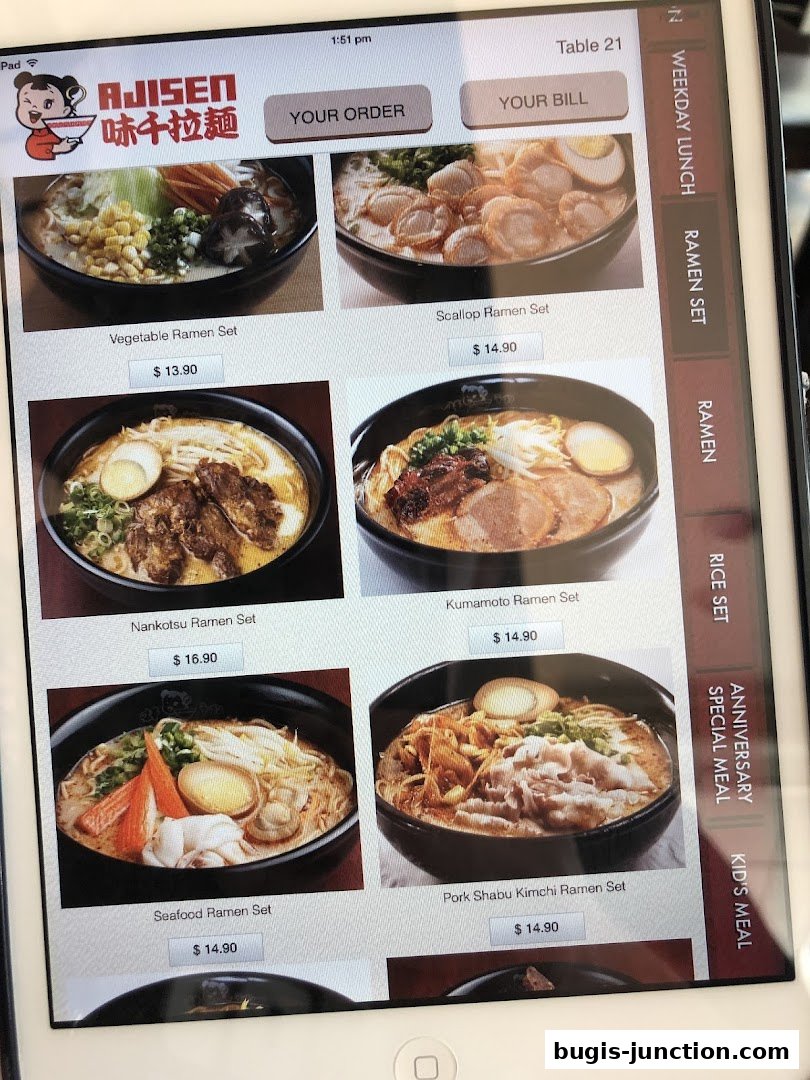 A tablet displaying a menu of Ajisen Ramen dishes with images and prices.
