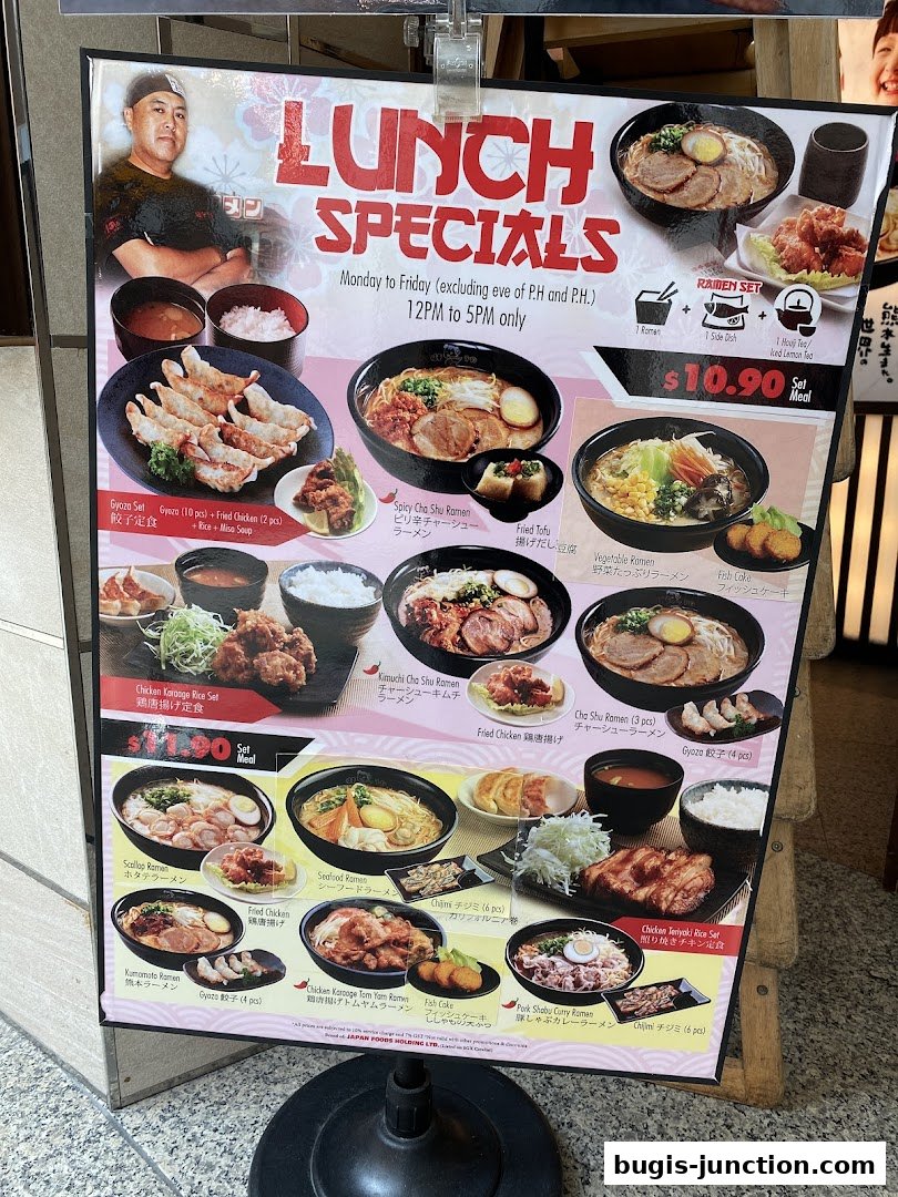 A colorful menu board showcasing various ramen sets and lunch specials from Ajisen Ramen.
