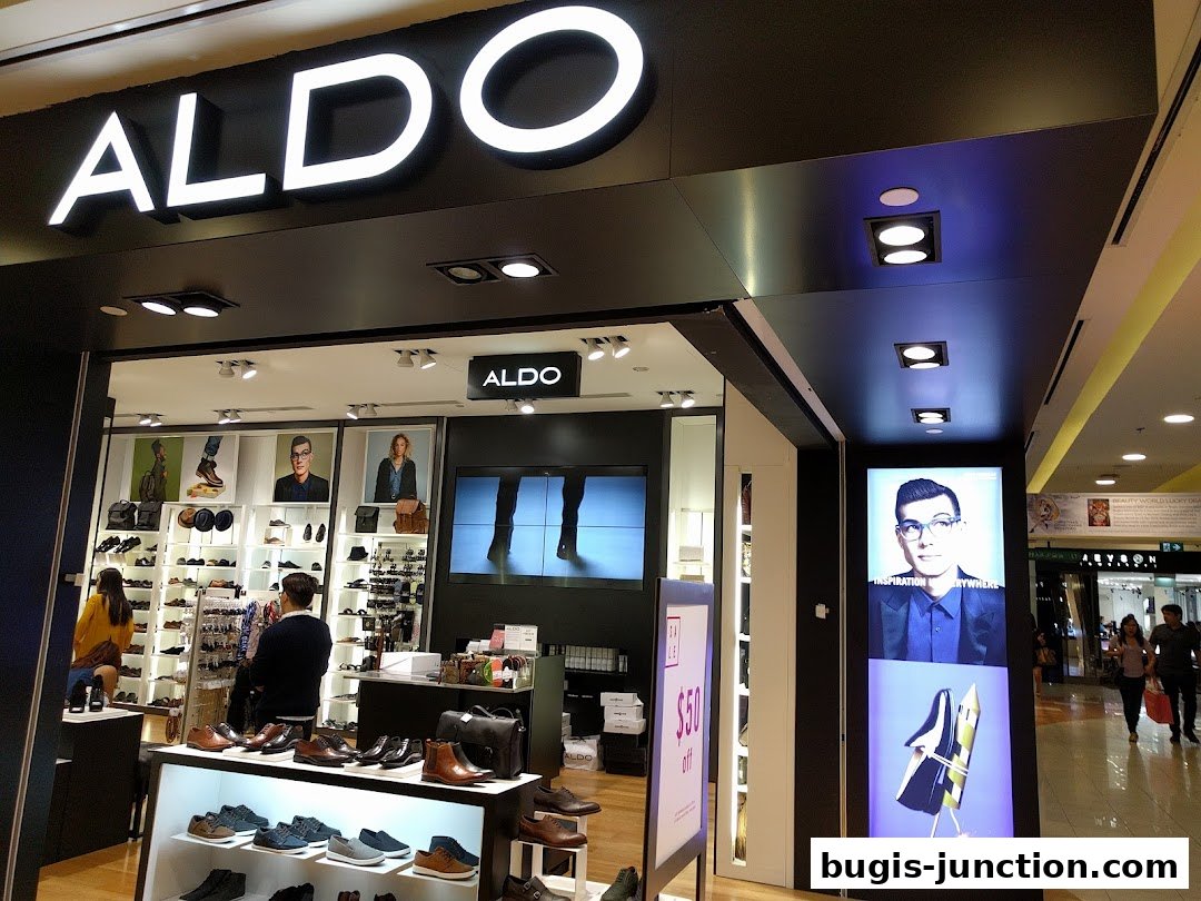 The ALDO shoe store features a well-lit interior with displays of shoes and bags, and promotional posters.