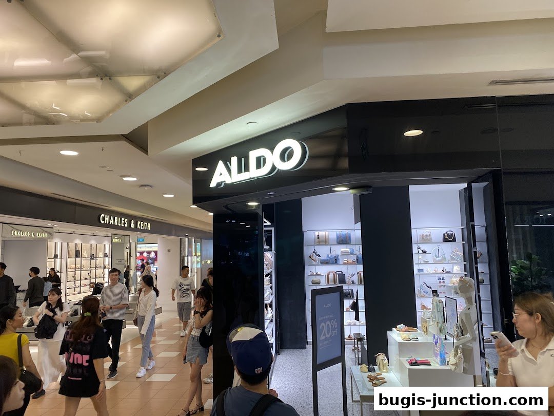 The ALDO store entrance with shoes and bags displayed, and shoppers in the mall.
