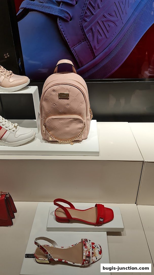 ALDO shop display featuring a pink backpack and various stylish sandals and sneakers.