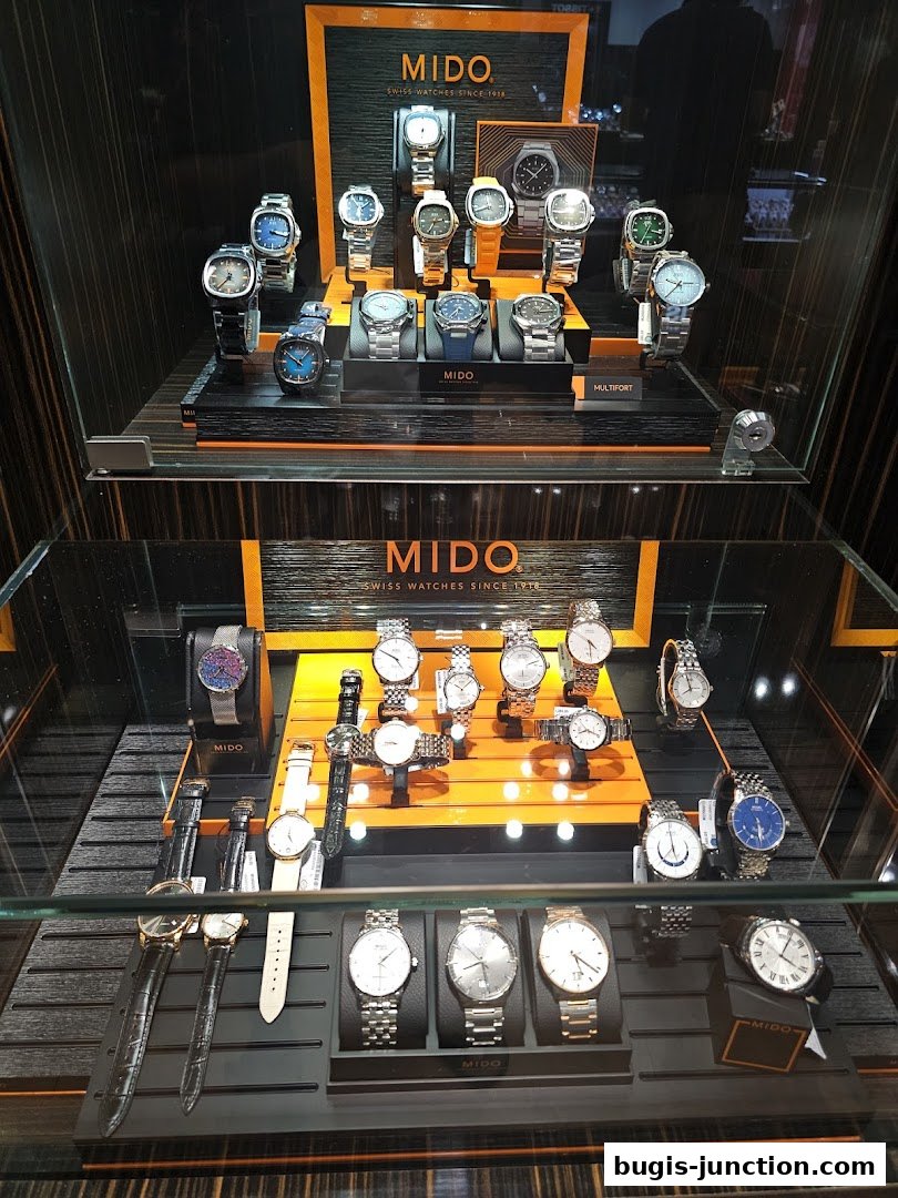 A display case showcasing a variety of Mido brand watches.