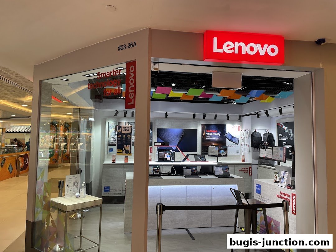 The entrance of a modern Lenovo store showcasing laptops and accessories.