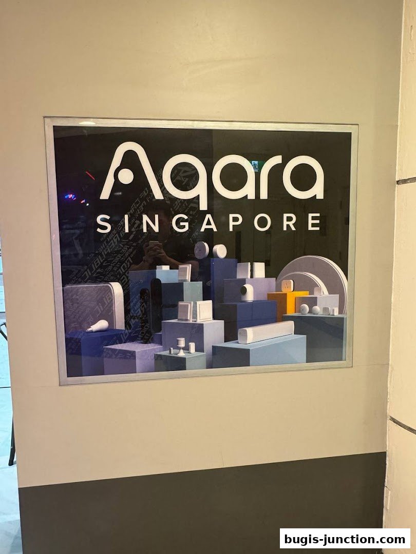 A sign for Aqara Home Exclusive Store in Singapore with a display of smart home devices.