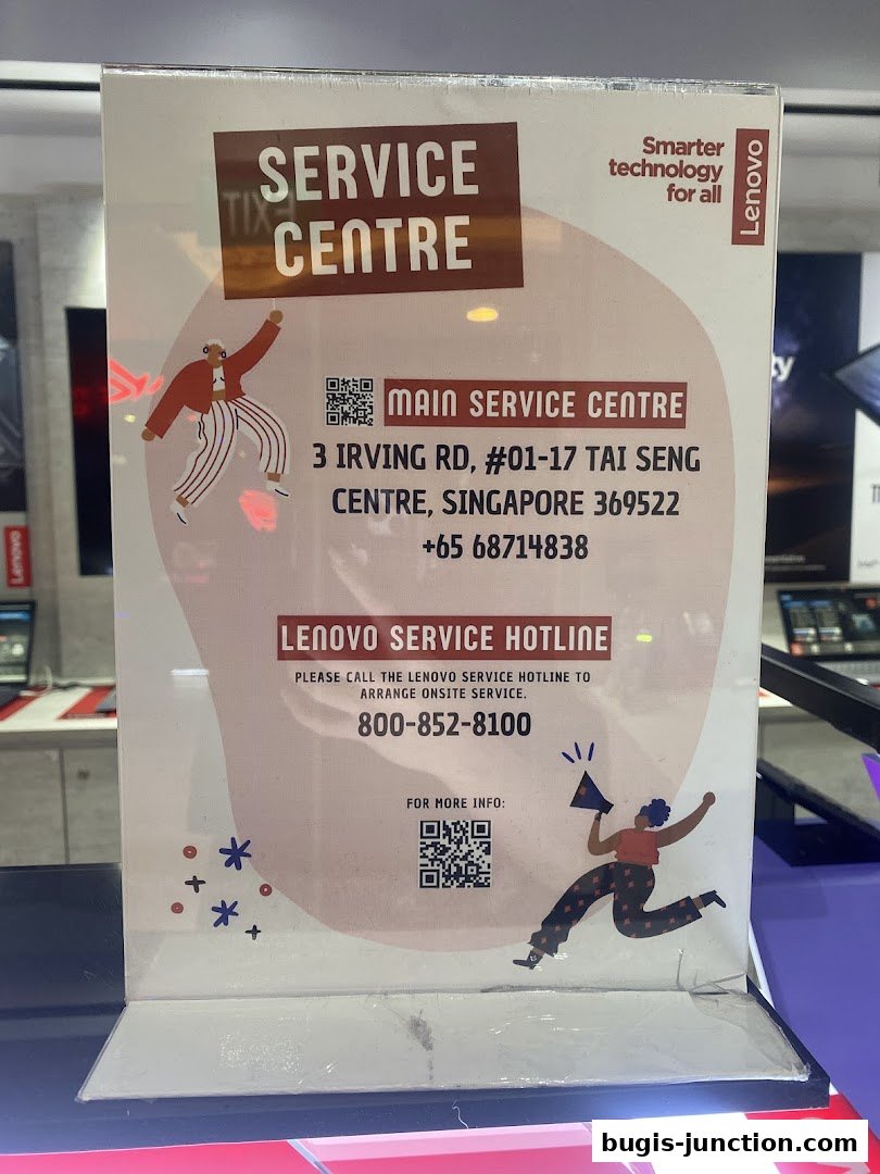 A sign for the Lenovo Service Centre with contact information and a hotline number.