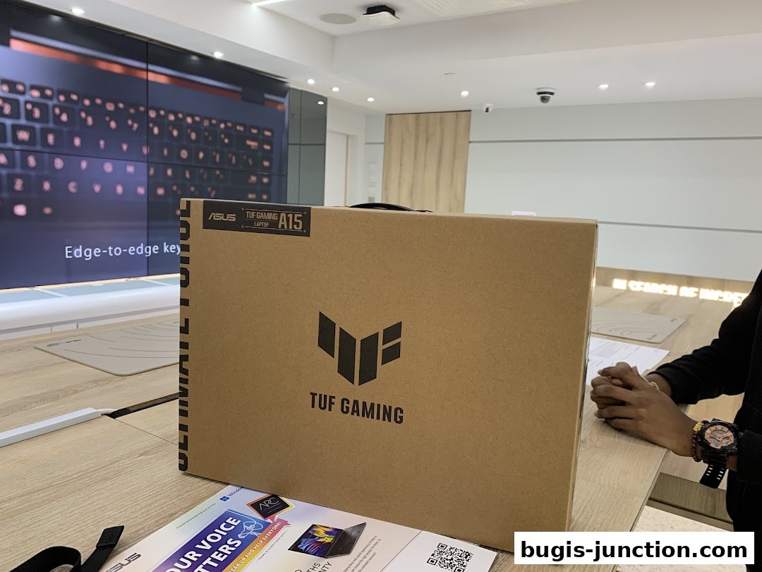 A cardboard box for an ASUS TUF Gaming A15 laptop is displayed in a store.