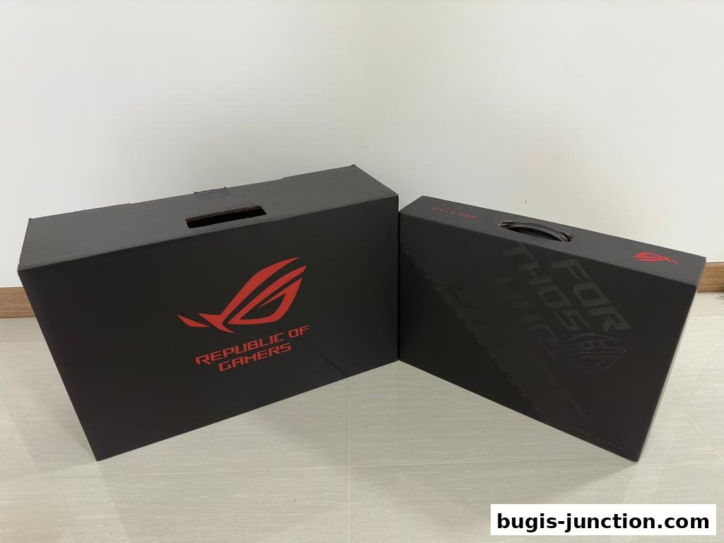 Two black ASUS ROG gaming laptop boxes with red logos and text.