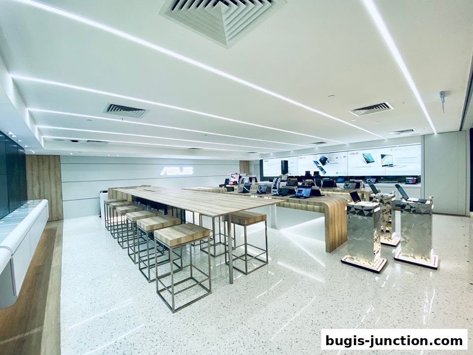Interior of an ASUS Exclusive Store with laptops on display and seating area.