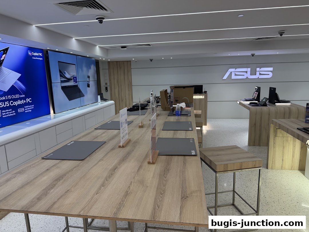 Interior of an ASUS Exclusive Store showcasing laptops and displays.