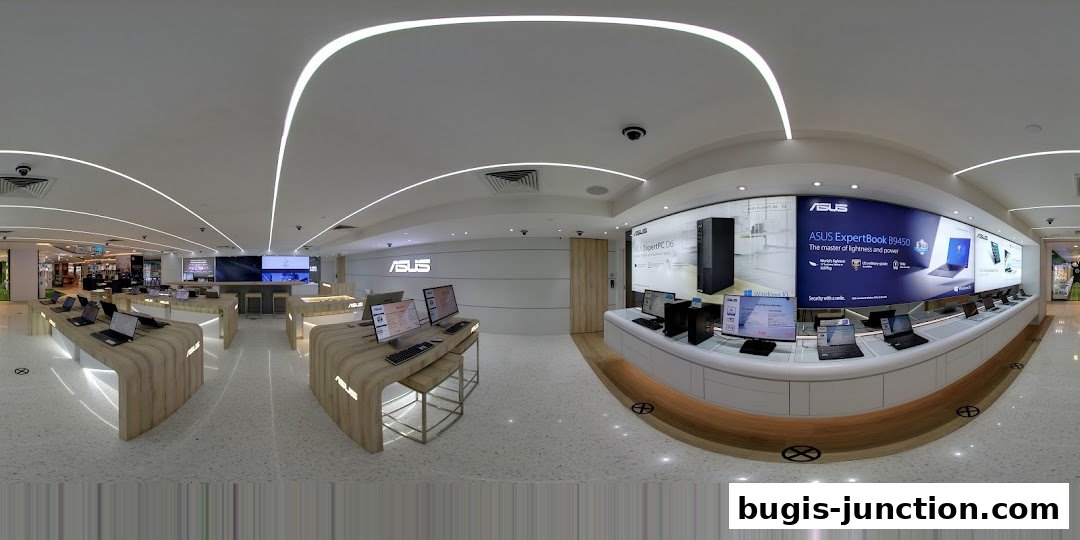 Interior view of an ASUS Exclusive Store showcasing laptops and computers on display.