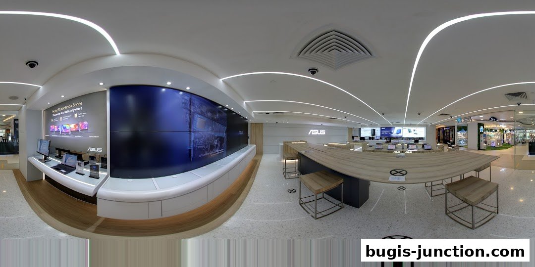 Interior view of an ASUS Exclusive Store showcasing laptops and a large display wall.
