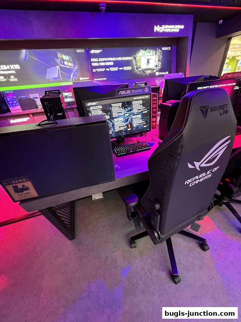 A gaming setup with an ASUS monitor, keyboard, and a Republic of Gamers chair.