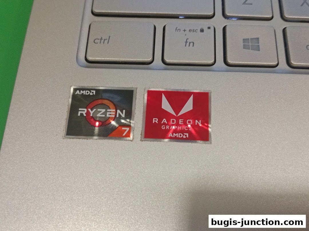 Close-up of AMD Ryzen 7 and Radeon Graphics stickers on a laptop keyboard.