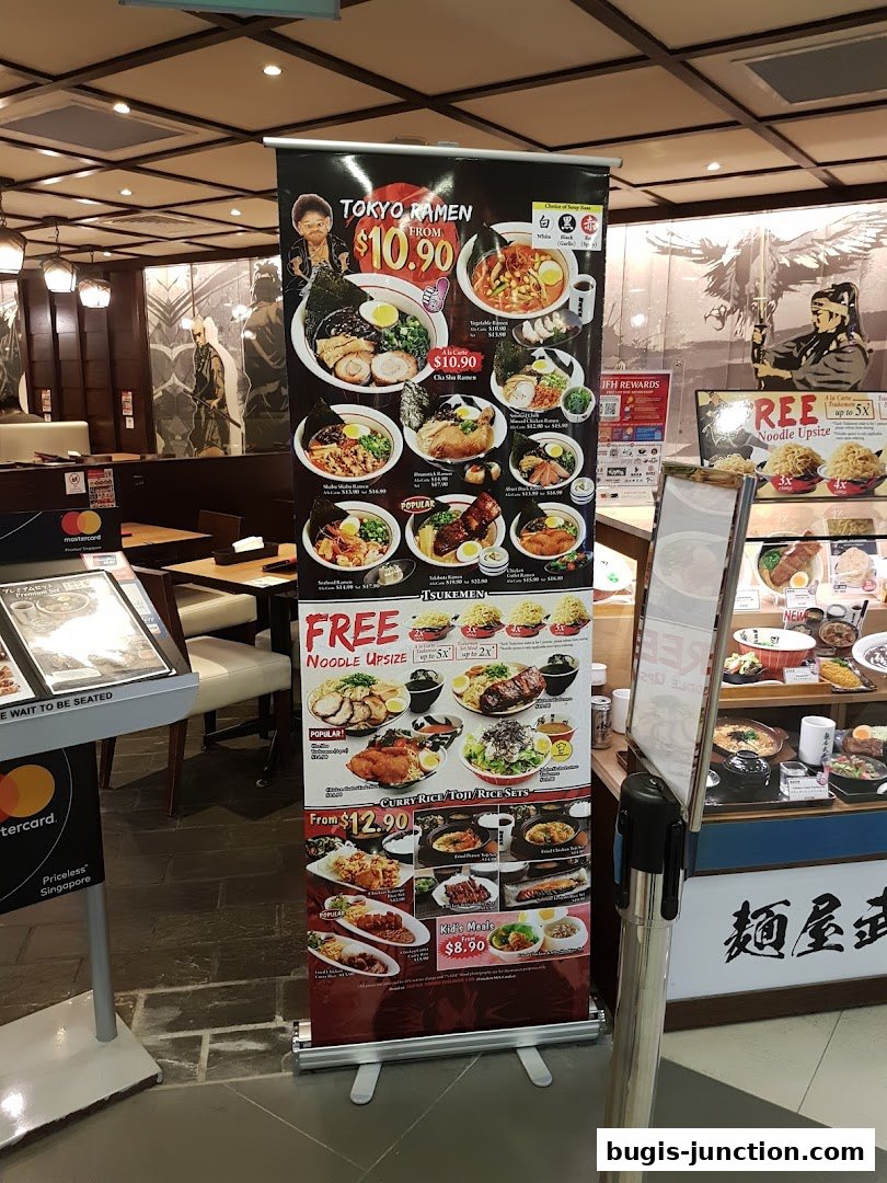 A display banner showcasing various ramen and rice set meals with prices and promotions.