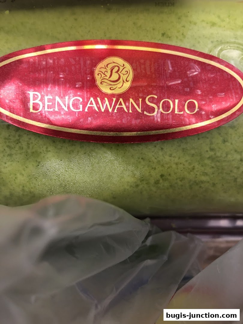 A close-up of a green cake with the Bengawan Solo logo on a red label.