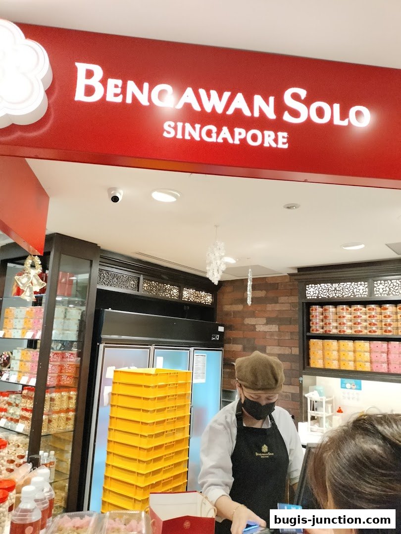 A shop counter at Bengawan Solo with a staff member serving a customer.