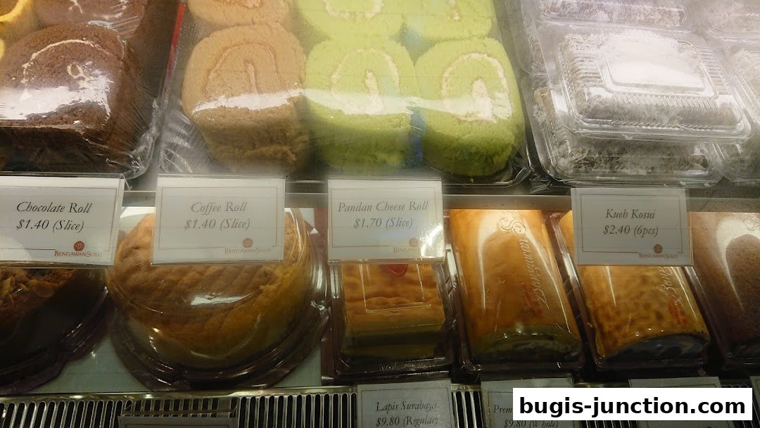 A display case filled with various cakes and rolls from Bengawan Solo.