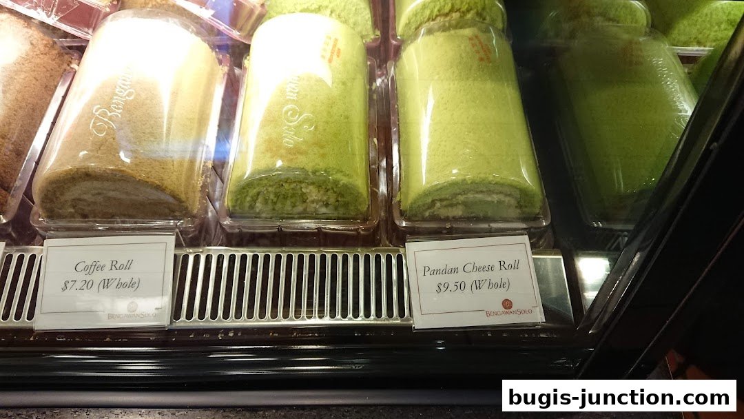 A display case featuring freshly baked coffee and pandan cheese rolls.