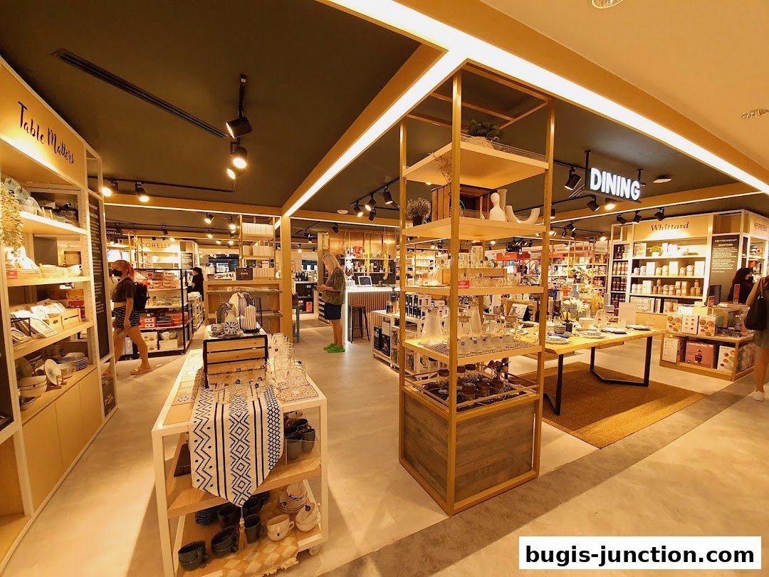 Interior view of a well-lit home goods store with displays of tableware and kitchenware.
