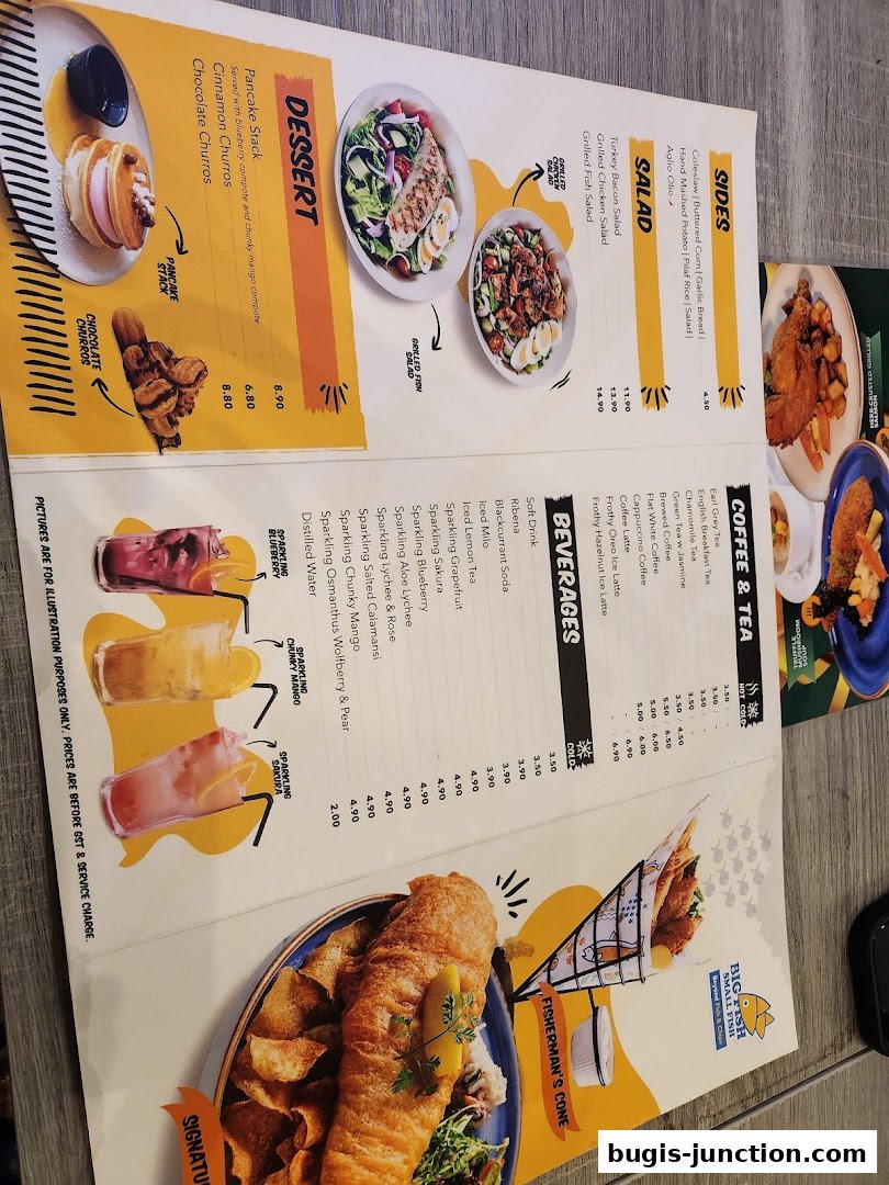 A menu from Big Fish Small Fish Bugis Junction featuring desserts, salads, sides, beverages, and coffee/tea options.