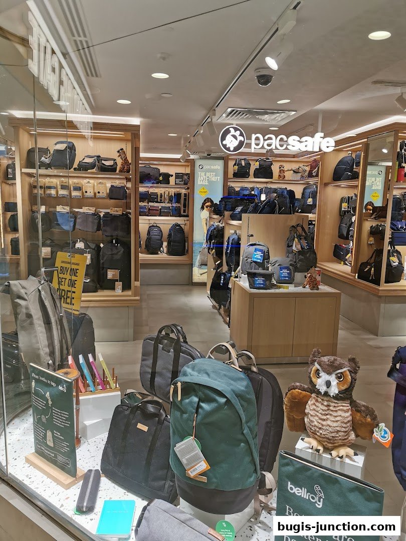 A shop window displaying various backpacks, bags, and accessories, with a plush owl.
