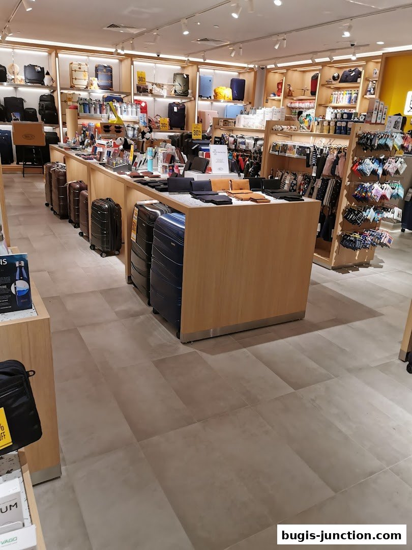 Interior view of a retail store displaying luggage, wallets, and travel accessories.