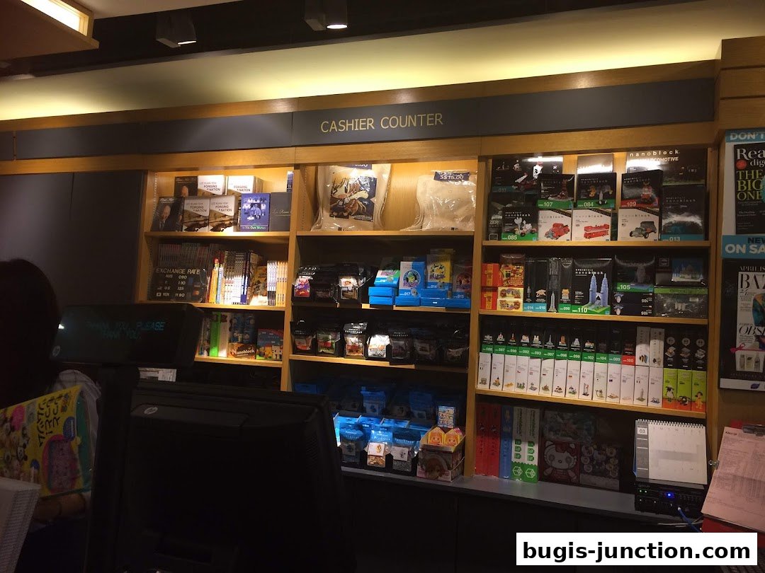 A cashier counter at Books Kinokuniya Bugis Junction, displaying books and merchandise.