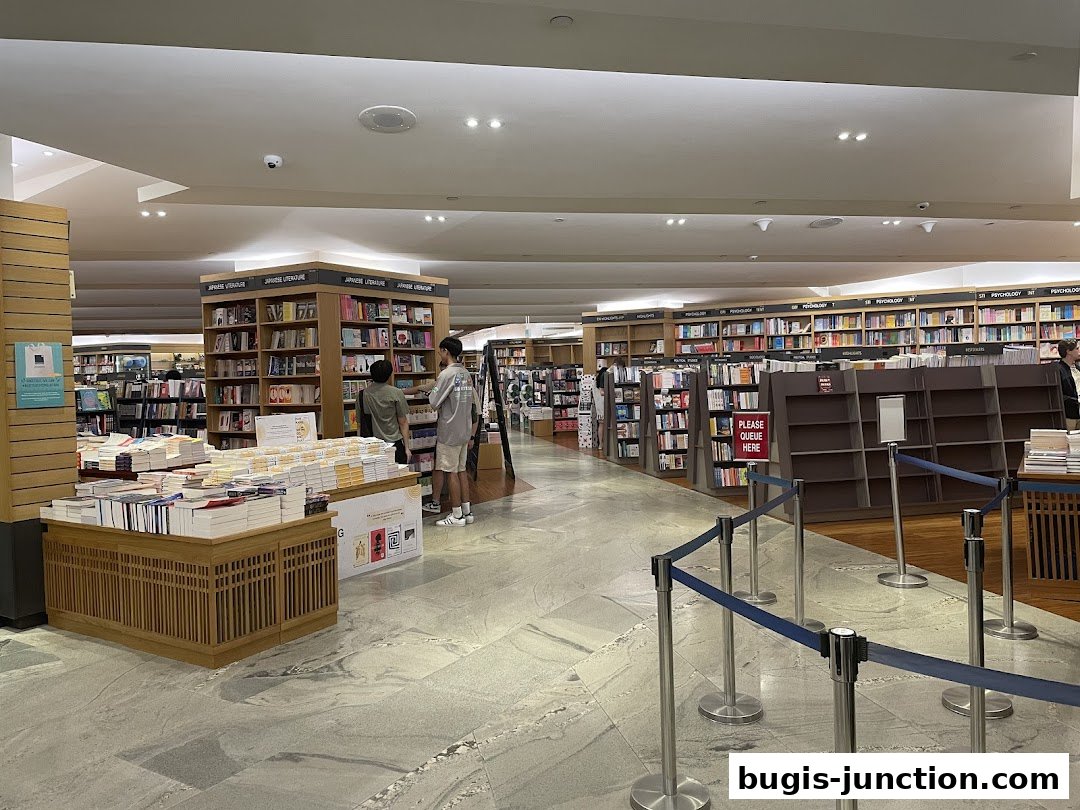 Interior view of a spacious bookstore with shelves full of books and customers browsing.