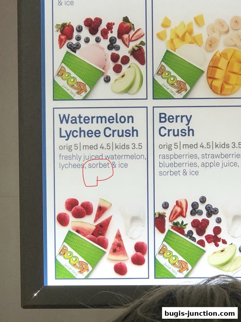 A menu board displaying two Boost Juice drinks: Watermelon Lychee Crush and Berry Crush.