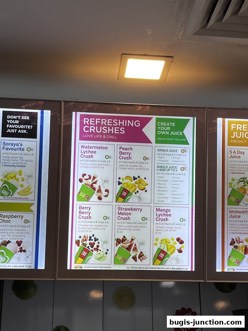 A menu board displaying various refreshing juice crushes and single juice options from Boost Juice.