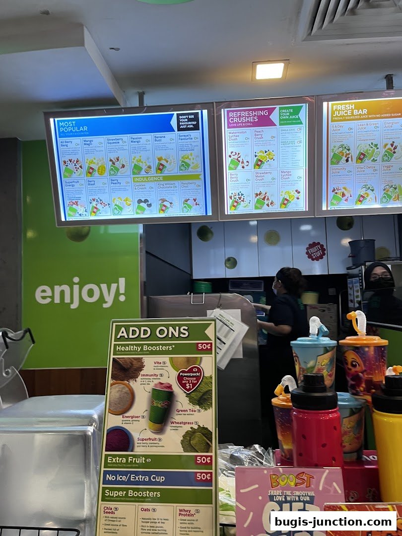 A menu board displaying popular juices, refreshing crushes, and fresh juice bar options with add-ons.