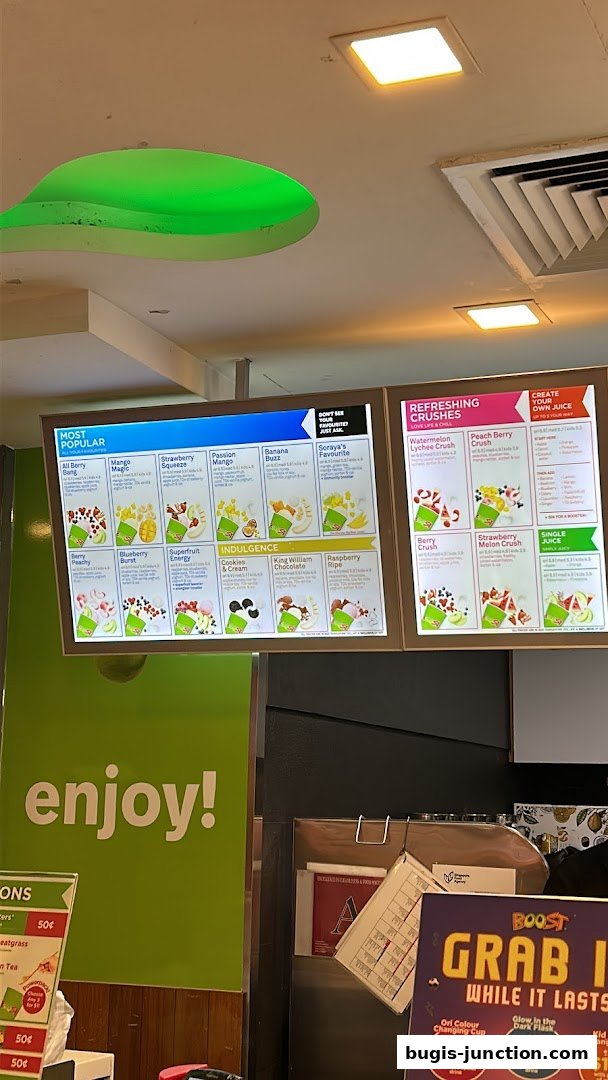 A menu board displaying various juice and smoothie options at Boost Juice.