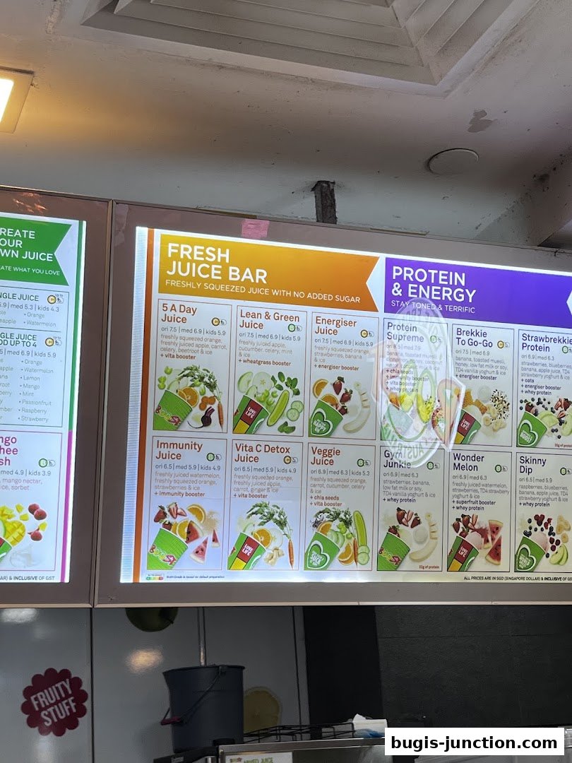 A brightly lit menu board displaying various fresh juices and protein drinks.
