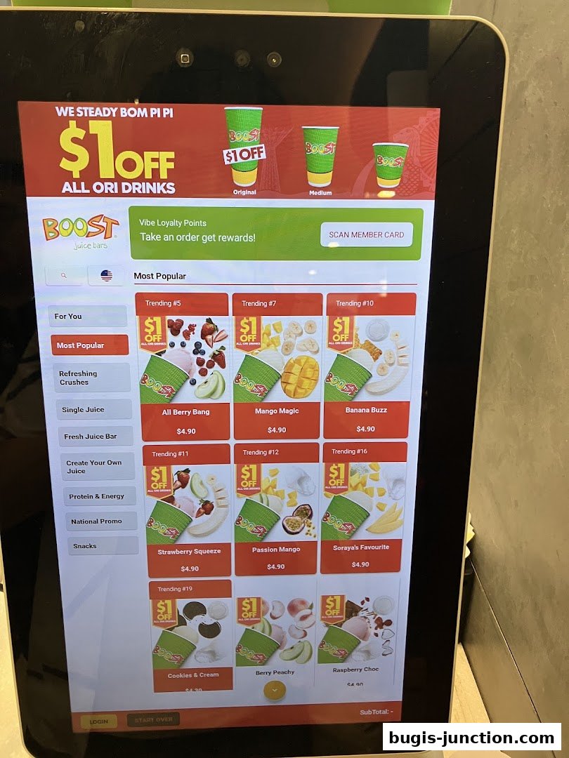 A digital menu screen displaying various Boost Juice drinks and promotions.
