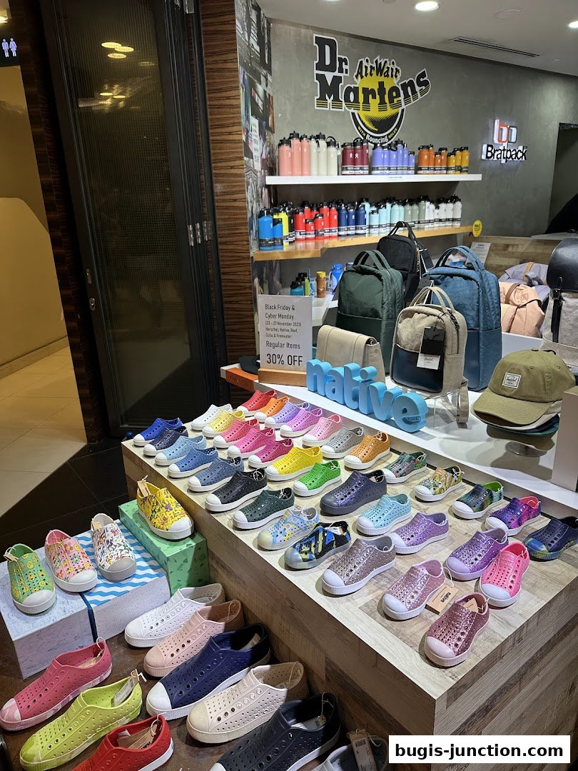 A retail shop display featuring colorful shoes, backpacks, and Dr. Martens merchandise.