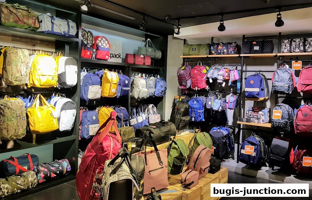 A wide selection of backpacks, duffel bags, and tote bags displayed on shelves and racks.