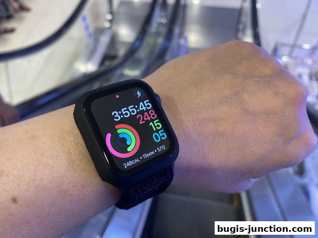 A person's wrist wearing a smartwatch with activity tracking displayed.