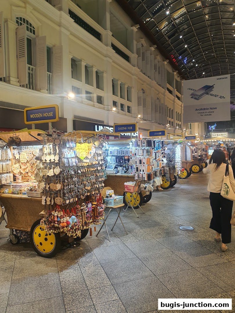 A row of market stalls selling phone cases and accessories, with a Samsung advertisement overhead.