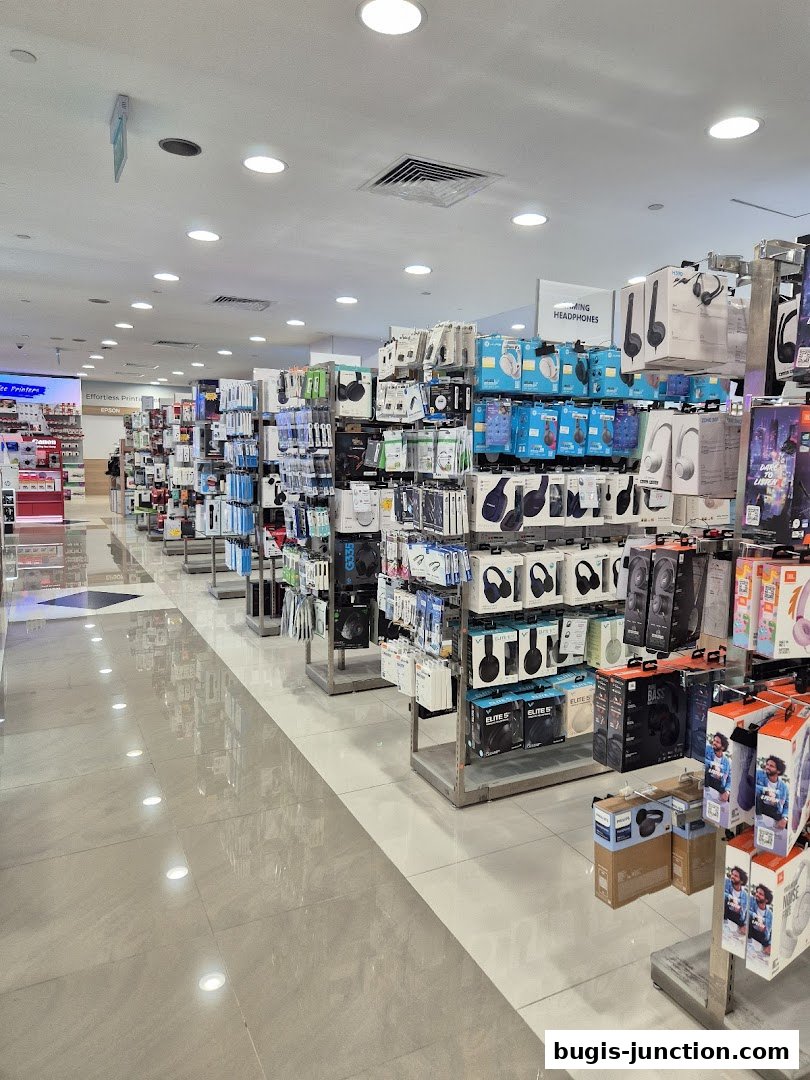 Interior view of a retail store showcasing a wide selection of headphones and electronics.