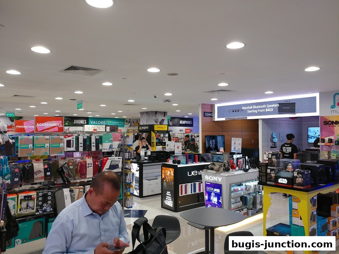 Interior view of a well-stocked electronics store with various gadgets and accessories on display.