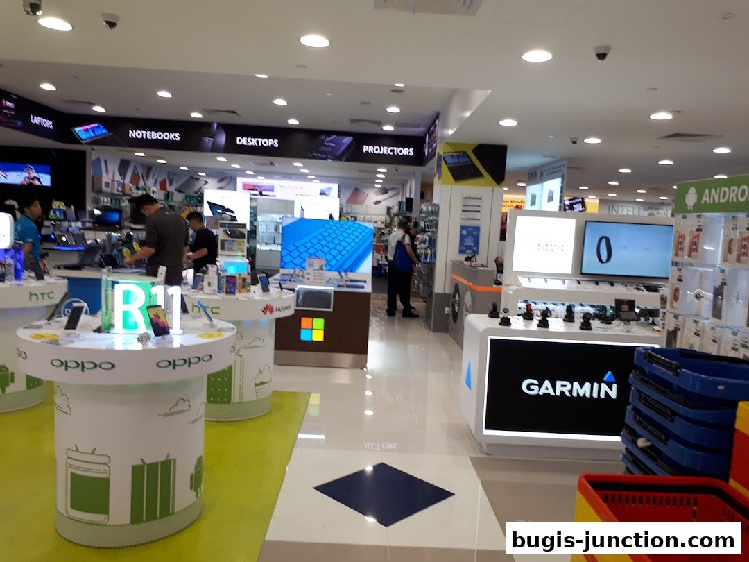 Interior view of a modern electronics store showcasing various gadgets and displays.