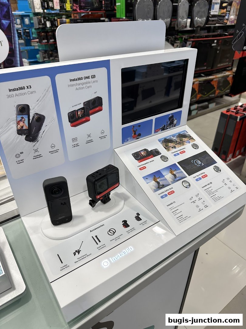 Display of Insta360 action cameras and accessories, including the X3 and ONE RS models.